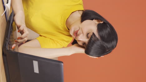 Vertical-video-of-The-young-woman-who-fell-asleep-in-front-of-a-laptop.